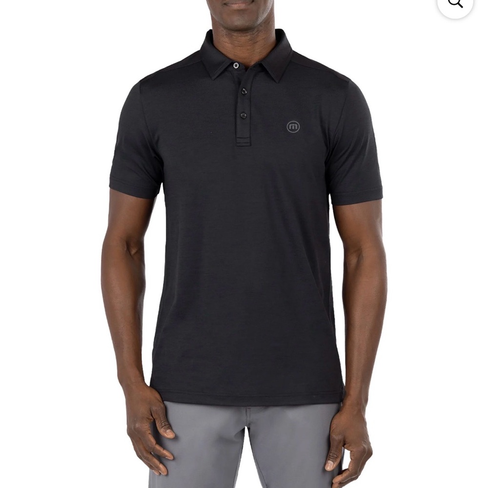Travis Mathew Heating Up men's golf polo in black.